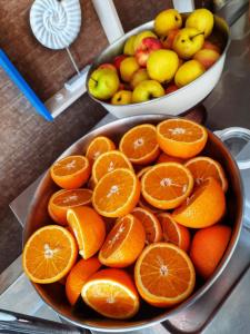 two bowls of oranges and other fruit on a counter at Hotel Riviera in Mamaia