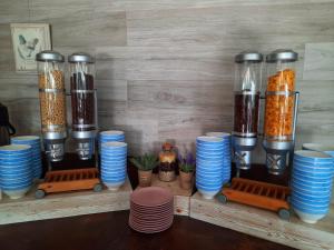 a shelf filled with blue and white plates and cups at Hotel Riviera in Mamaia