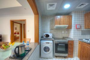 A kitchen or kitchenette at La Villa Najd Hotel Apartments