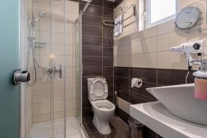 a bathroom with a toilet and a sink at Cirillo Family Hotel-Christinas Studios in Mastihari