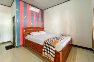 Postel nebo postele na pokoji v ubytování Ekas Beach Guesthouse Mitra RedDoorz