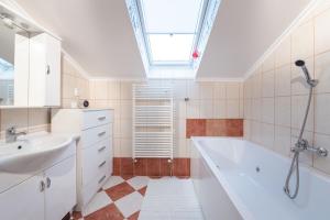 a bathroom with a sink and a bath tub at Villa DonLeone in Ponikva