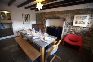 a dining room with a table and a red chair at Penkenna House, Crackington Haven, North Cornwall in Crackington Haven