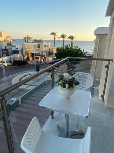 un tavolo e sedie su un balcone con vista sull'oceano di Player Sea View apartment a Paphos