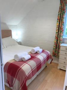 a bedroom with a bed with two towels on it at The Hayloft in Abergavenny