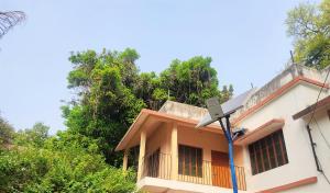 a house with a street light in front of it at KASAHARA - HOMESTAY in Bolpur