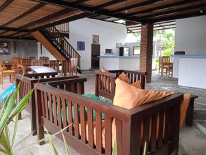a living room with two benches and a table at family house hotel kuta in Kuta Lombok