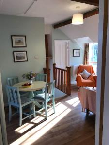 a living room with a table and chairs at The Hayloft in Abergavenny