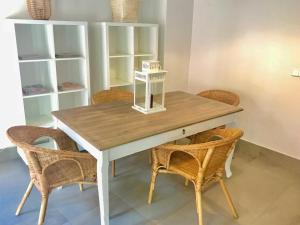 a dining room table with two chairs and a white table at LovelyLoft Castaños in Alicante
