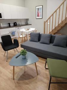 - un salon avec un canapé, des chaises et une table dans l'établissement Apartamento pacifico a, à Madrid