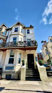 a large white building with a balcony on top of it at The Hedley Townhouse in Bournemouth