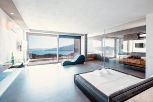 a bedroom with a bed and a large window at Luxury Villa for 8 with 20m large Infinity Pool in Kalkan in Kaş