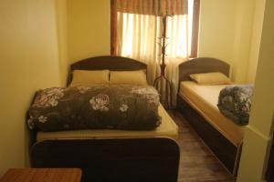 Postelja oz. postelje v sobi nastanitve Universal Hotel & Lodge - Gorkha