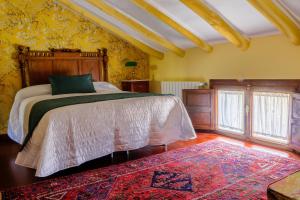 a bedroom with a large bed and a rug at Molino Sauco - Hammam in Puebla de Don Fadrique