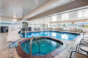 a pool in a hotel room with tables and chairs at Best Western Firestone Inn & Suites in Longmont