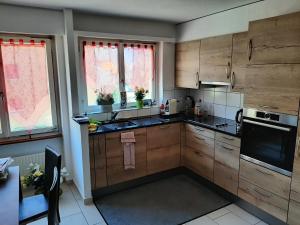 a kitchen with wooden cabinets and a stove top oven at Casablanca in Sion
