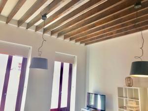 a living room with two lights hanging from the ceiling at LovelyLoft Castaños in Alicante