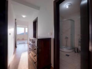 a bathroom with a wooden dresser and a mirror at Apartments Branko in Budva