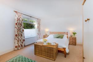 a bedroom with a bed and a window at Beau Vista Ground Floor Apartment in Padstow
