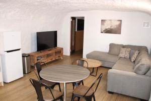 a living room with a couch and a table at Holly Place in Coober Pedy
