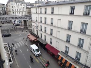 a white van parked in front of a building at Dupleix Hotel in Paris