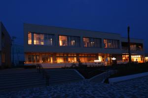 a large building at night with its lights on at Toriizaki Club HOTEL and SEAFOODS in Kisarazu