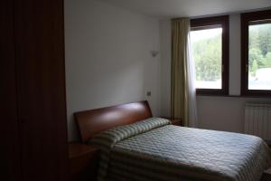 a bedroom with a bed and a window at Appartamenti Campo Smith in Bardonecchia +41 photos