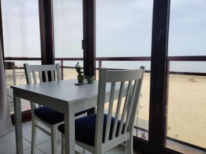 a table and two chairs sitting next to a window at Beachview Pier Blankenberge in Blankenberge