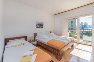Posteľ alebo postele v izbe v ubytovaní Apartments Clarus Mare