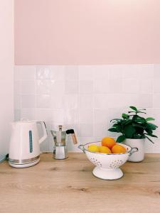 a bowl of oranges on a counter in a kitchen at Studio d'architecte à 150 m de la plage in Royan