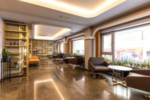a library with couches and tables and bookshelves at Hotel Venera in Istanbul