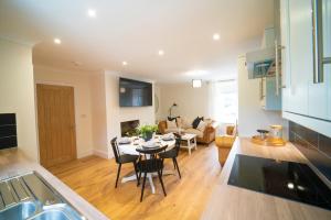 a kitchen and living room with a table and chairs at Foundry Farm Cottage in Hexham