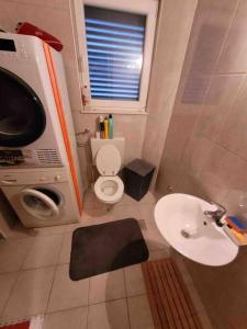 a small bathroom with a toilet and a sink at 2 bedroom apartment on the coast of the Adriatic! Watermelon Marina in Marina
