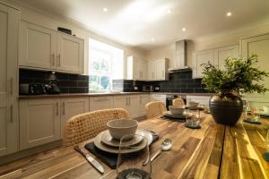 a kitchen with a wooden table with a vase on it at Foundry Farm House in Hexham