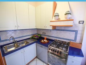 a kitchen with a sink and a stove at Appartamento Corso Italia 269 in Sorrento