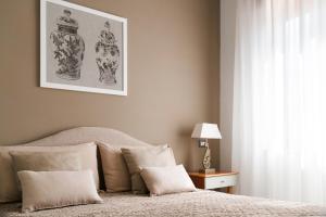 a bedroom with a bed with a picture on the wall at Appartamento Corso Italia 269 in Sorrento