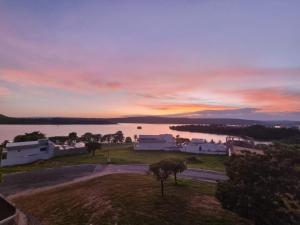 a view of a sunset over a body of water at Enseada Nautico Apart Flat I Vista para o Lago Corumbá in Caldas Novas