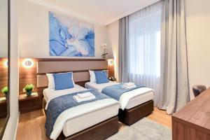 Krevet ili kreveti u jedinici u okviru objekta Hotel Opera Garni