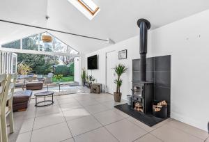 a living room with a fireplace in a house at Kittiwake in Highcliffe