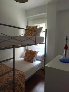 a room with two bunk beds and a table at Santa Justa in Seville