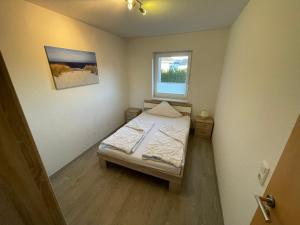 Ein Bett oder Betten in einem Zimmer der Unterkunft Wangernest