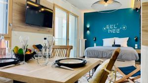 a room with a dining table and a bed at Studio BEL MOD Mont d'Or - Belvédère Moderne in Lyon