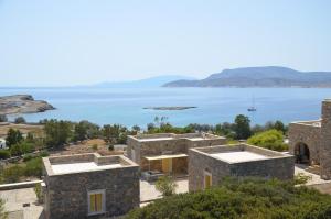 an old stone house with a view of the ocean at Archipelagos Boutique Hotel in Schinoussa
