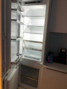 an empty refrigerator with its door open in a kitchen at Garou in Luxembourg +16 photos