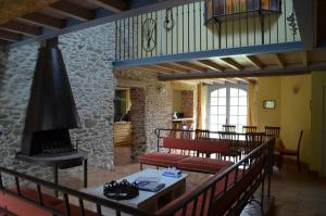 a living room with a fireplace and a stone wall at Les Roses d'Autan in Auriac-sur-Vendinelle