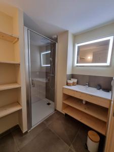 a bathroom with a shower and a sink at Les Chalets de l'Adret in Le Grand-Bornand