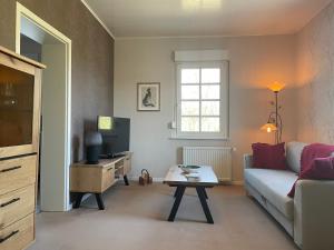 a living room with a couch and a table at Ferienwohnung Annika in Hückeswagen