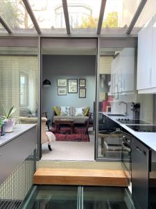 a kitchen with a view of a living room at Maison exceptionnelle, Campagne a Paris in Paris