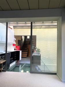 a room with a glass door leading to a staircase at Maison exceptionnelle, Campagne a Paris in Paris