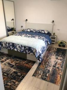 a bedroom with a bed with a mirror and a rug at Brand New Downtown Studio in Bucharest